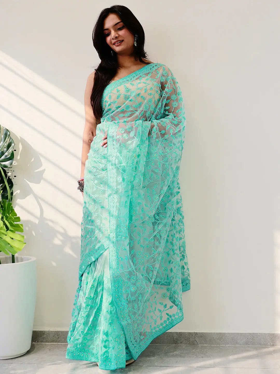 Elegant Saree Adorned with Ethnic Motifs, Intricate Threadwork, and Embellished Borders