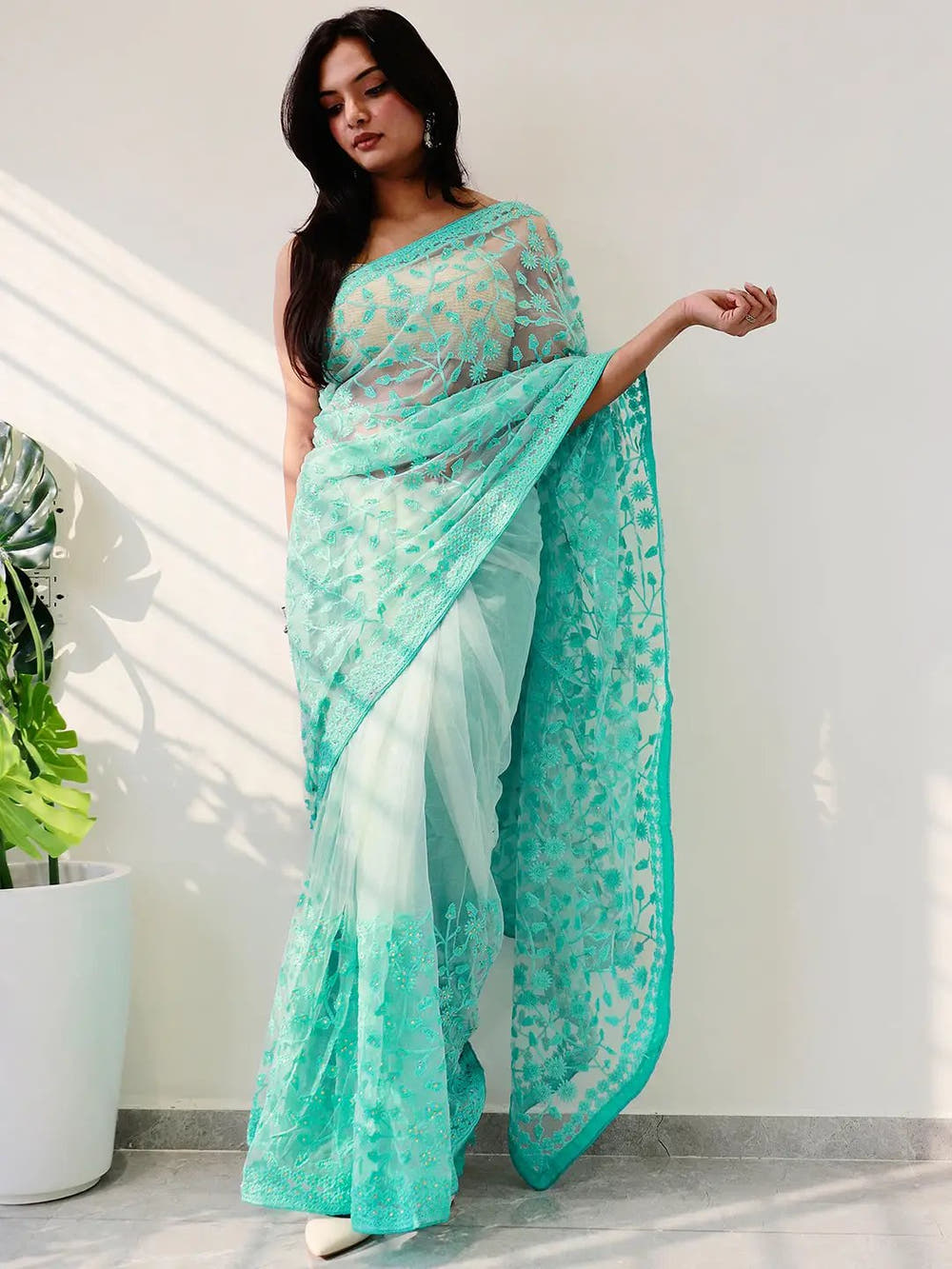Elegant Saree Adorned with Ethnic Motifs, Intricate Threadwork, and Embellished Borders