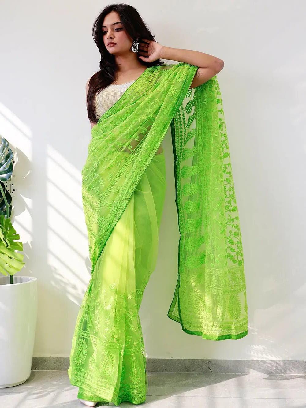 Elegant Saree Adorned with Ethnic Motifs, Intricate Threadwork, and Embellished Borders