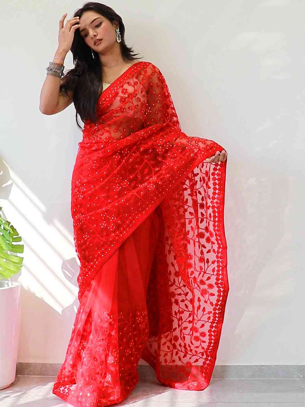 Elegant Saree Adorned with Ethnic Motifs, Intricate Threadwork, and Embellished Borders