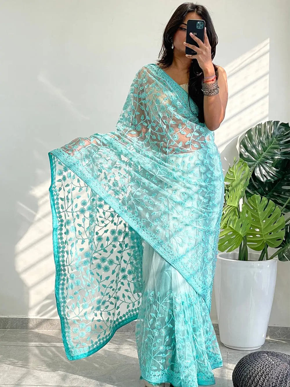 Elegant Saree Adorned with Ethnic Motifs, Intricate Threadwork, and Embellished Borders