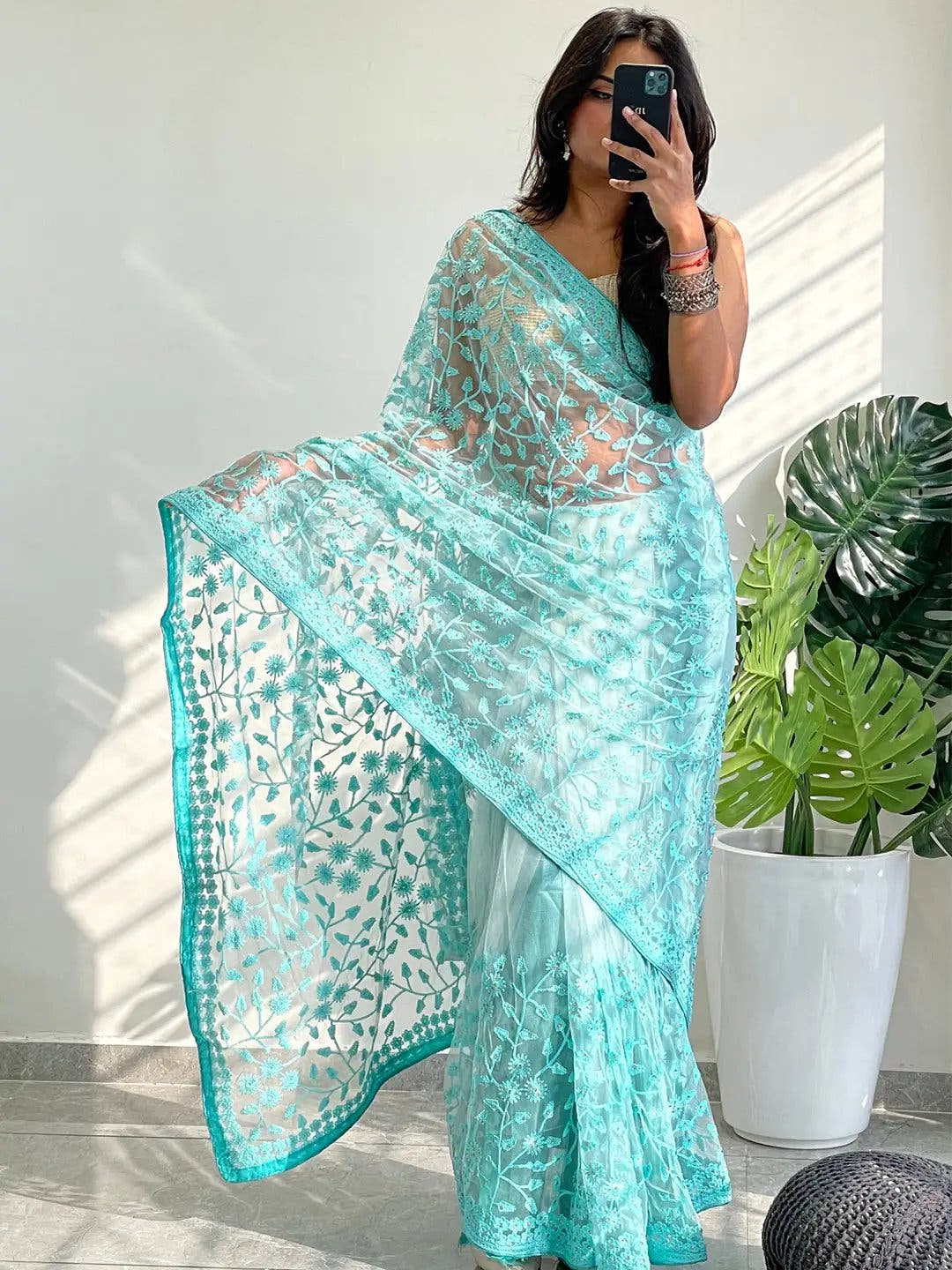 Elegant Saree Adorned with Ethnic Motifs, Intricate Threadwork, and Embellished Borders