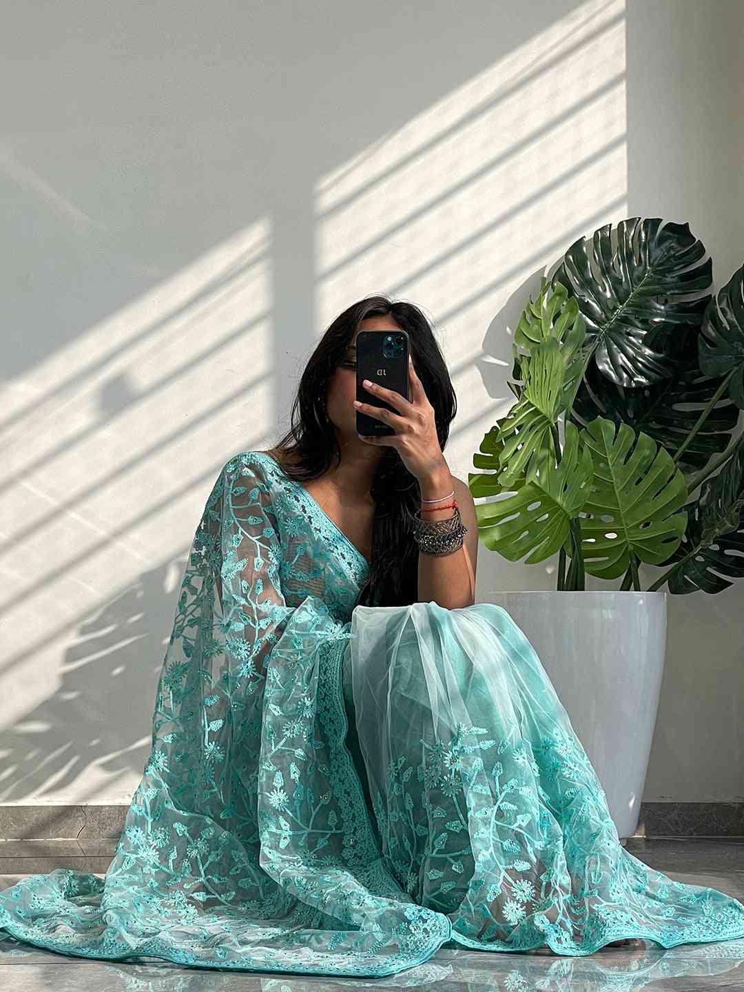 Elegant Saree Adorned with Ethnic Motifs, Intricate Threadwork, and Embellished Borders